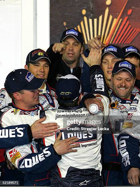 Jimmie Johnson, driver of the Hendrick Motorsports Lowe's Chevrolet, celebrates with teammates after winning the Bud Shootout in the NASCAR Nextel...