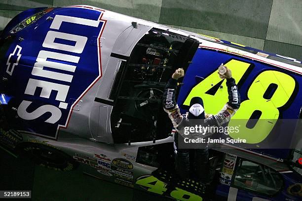 Jimmie Johnson, driver of the Hendrick Motorsports Chevrolet, celebrates in victory lane after winning the Budweiser Shootout, part of the NASCAR...