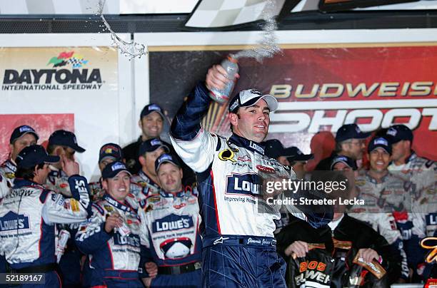 Jimmie Johnson, driver of the Hendrick Motorsports Lowe's Chevrolet, celebrates with teammates after winning the Bud Shootout in the NASCAR Nextel...