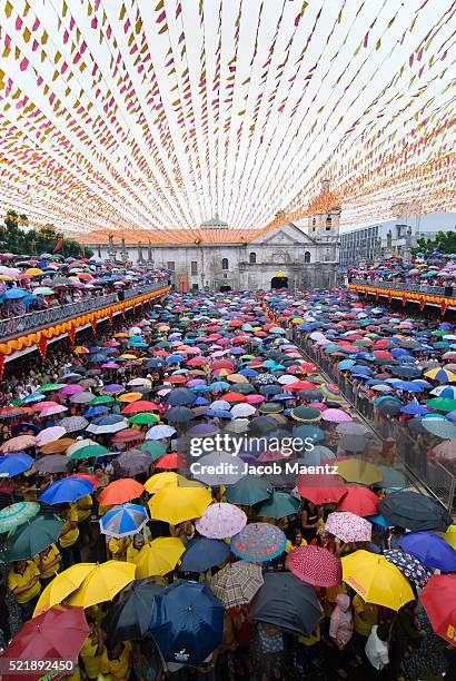 hundreds of umbrellas during a rainy mass at basilica del santo nino - filipino festival stock pictures, royalty-free photos & images