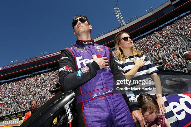 Denny Hamlin, driver of the FedEx Freight Toyota, stands on the grid with his girlfriend, Jordan Fish, and daughter, Taylor, prior to the NASCAR...