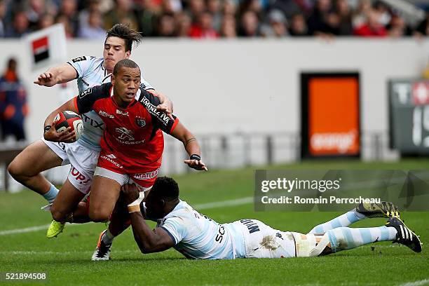 Gael Fickou for Toulouse is tackled by Yannick Nyanga and Sean Robinson for Racing 92 during the French Top 14 rugby union match between Toulouse v...