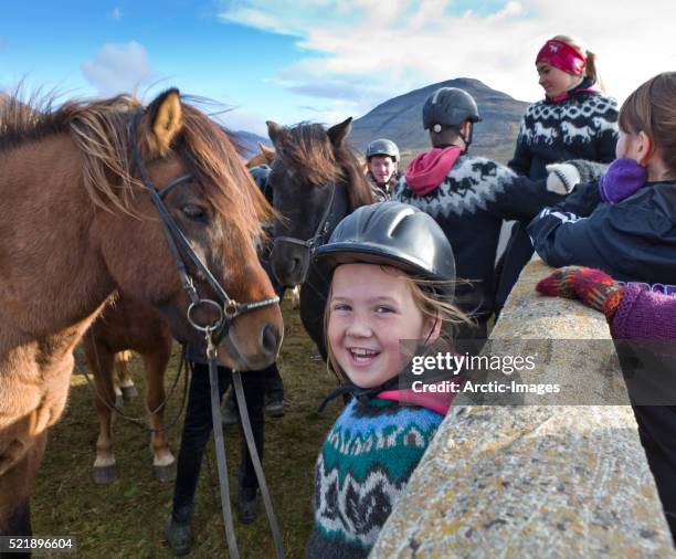 young girl enjoying the day at the annual horse round up, laufskalarett, iceland - skagafjordur stockfoto's en -beelden
