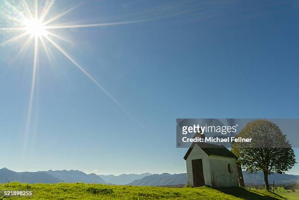 chapel overlooking bavarian alps - lake riegsee stock pictures, royalty-free photos & images