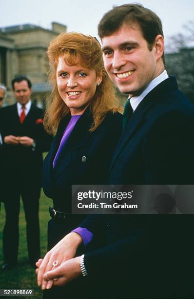 Prince Andrew with Sarah Ferguson at Buckingham Palace after the announcement of their engagement, London, 17th March 1986. Ferguson's white and...