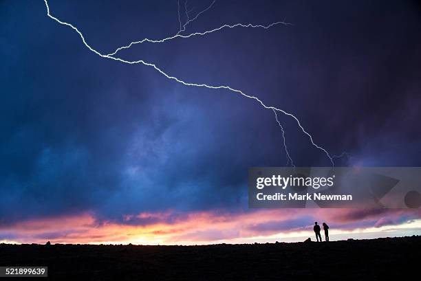 two hikers silhouetted and lightning - thunderstorm stock pictures, royalty-free photos & images