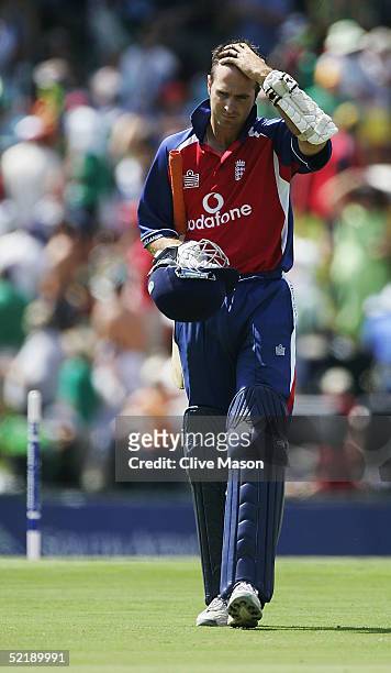 Michael Vaughan of England walks back to the dressing room after being clean bowled by Makhaya Ntini of South Africa during the seventh and final one...