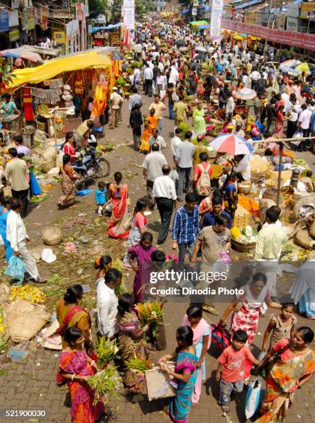 crowd in flower market purchasing articles decorate idols lord ganesh, celebrating ganapati festival at dadar, bombay mumbai - asia lady selling flower stock pictures, royalty-free photos & images