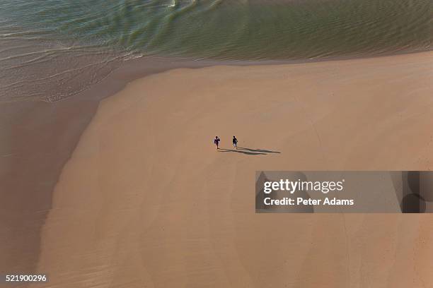 aerial view of people on beach huelva province, spain - huelva province stock-fotos und bilder