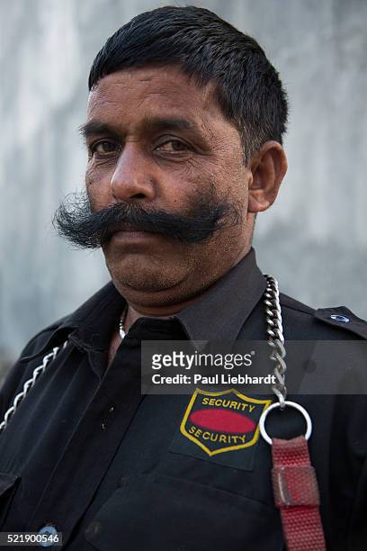 a well moustached security guard - bigote manillar fotografías e imágenes de stock