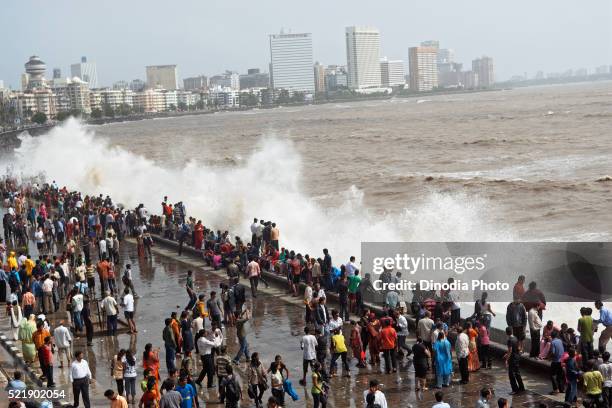 people enjoying hightide waves at marine drive bombay, mumbai, maharashtra, india - enjoy monsoon stock-fotos und bilder