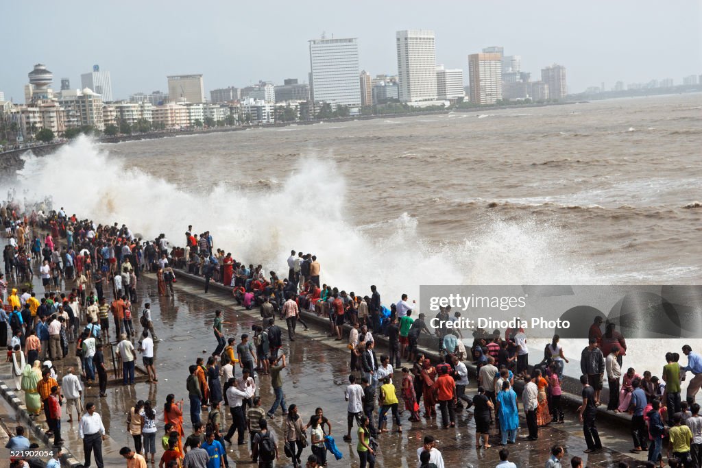 People enjoying hightide waves at marine drive Bombay, Mumbai, Maharashtra, India