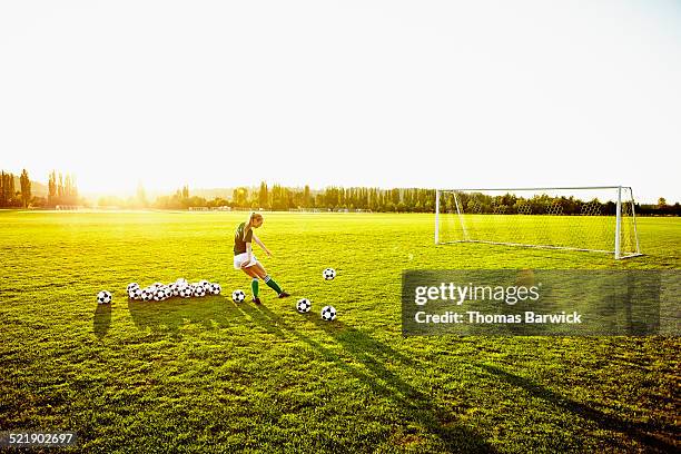 female soccer player practicing penalty kicks - soccer net stock pictures, royalty-free photos & images