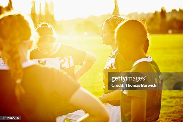 female soccer teammates in discussion on field - jamaican girl stock pictures, royalty-free photos & images