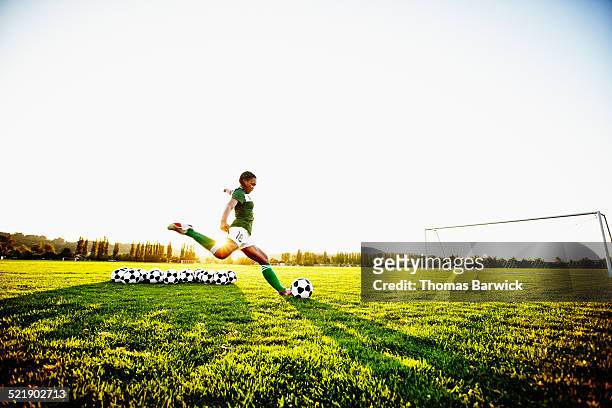 female soccer player practicing penalty kicks - falta término deportivo fotografías e imágenes de stock