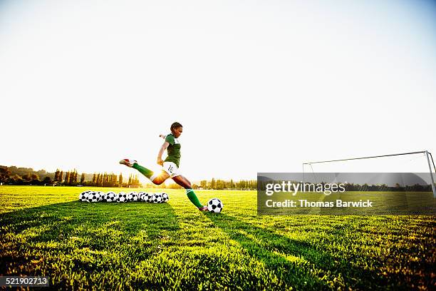 female soccer player practicing penalty kicks - straff sportaktivitet bildbanksfoton och bilder