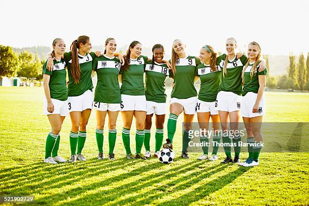group portrait of smiling female soccer team - american football strip - fotografias e filmes do acervo