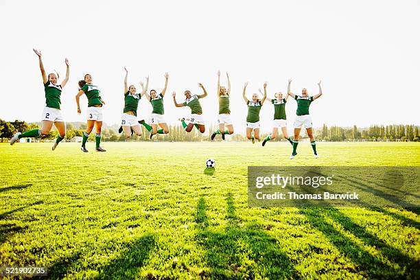 female soccer team jumping together in mid air - washington football team fotografías e imágenes de stock