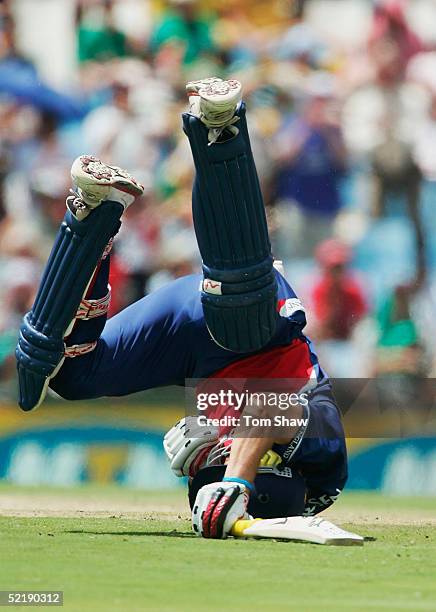 Kevin Pietersen of England rolls on the ground after colliding with Makhaya Ntini of South Africa to bring up his century during the seventh One Day...