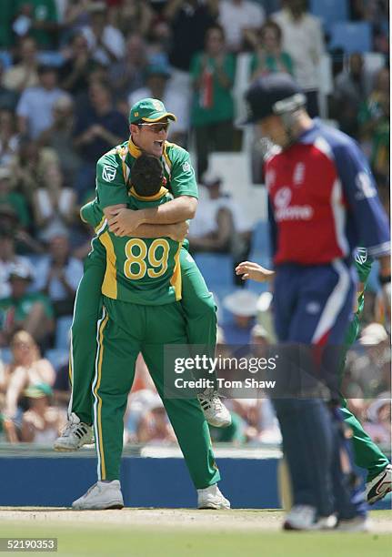 Graeme Smith of South Africa celebrates with Andre Nel after the dismissal of Andrew Strauss of England, during the 7th One Day International between...