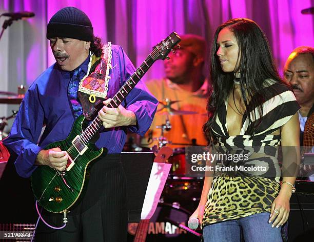 Musicians Carlos Santana and Alicia Keys perform onstage at the Clive Davis Grammy Party at the Beverly Hills Hotel on February 12, 2005 in Beverly...