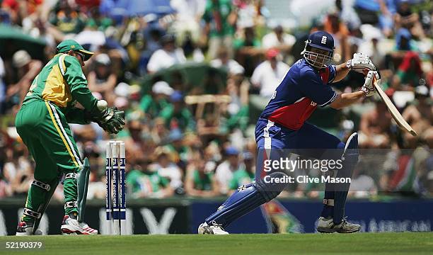 Ashley Giles of England in action batting watched by Mark Boucher of South Africa, during the seventh and final one day international match between...