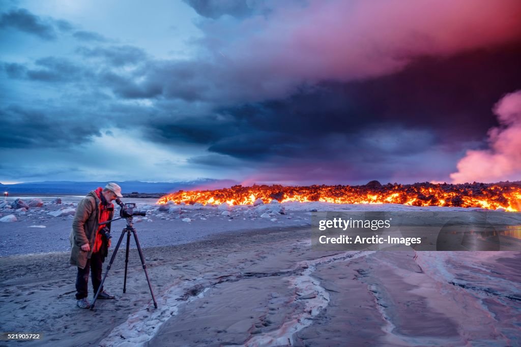 Photographer filming the volcano eruption at the Holuhraun Fissure, near the Bardarbunga Volcano, Ic