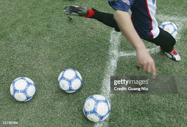 Chinese young soccer player practises a corner ball during a training course on February 11, 2005 in Qingyuan, Guangdong province, China. More than...