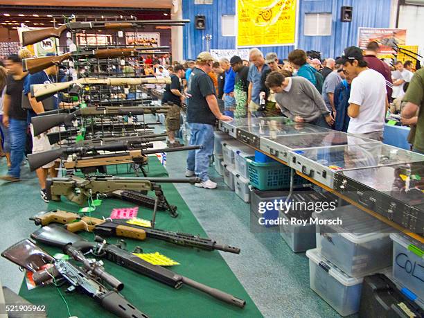 assault semi-automatic shot guns and assault rifles, both semi and automatic - gun show stock pictures, royalty-free photos & images