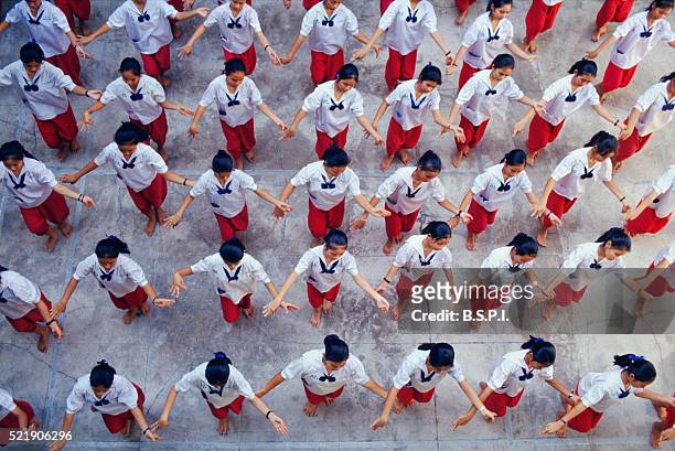 students practicing traditional thai dance - all dressed the same stock pictures, royalty-free photos & images