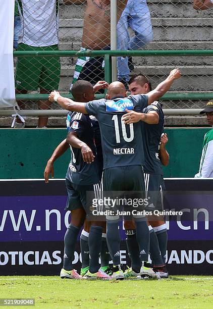 Maximiliano Nuñez of Millonarios celebrates with teammates after scoring the opening goal during a match between Deportivo Cali and Millonarios as...