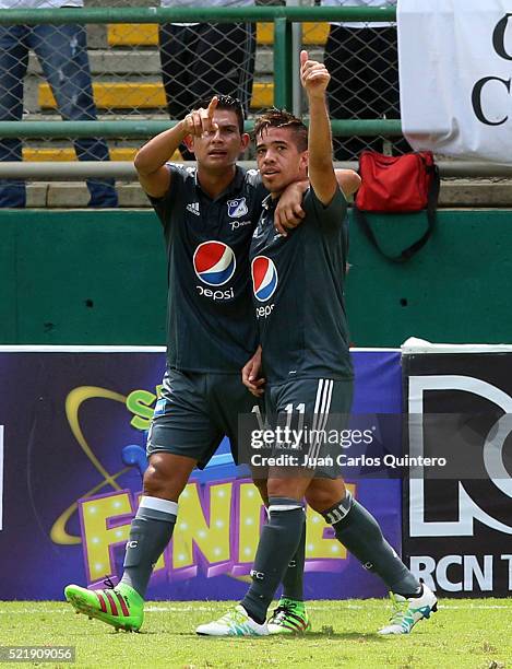 Maximiliano Nuñez of Millonarios ceelbrates with teammate David Silva during a match between Deportivo Cali and Millonarios as part of round 13 of...