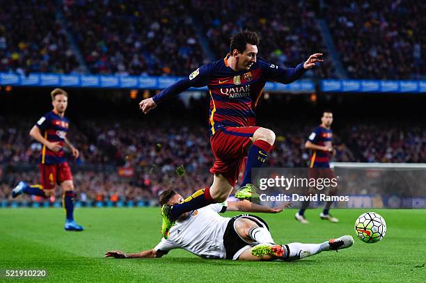 Lionel Messi of FC Barcelona competes for the ball with Guilherme Siqueira of Valencia CF during the La Liga match between FC Barcelona and Valencia...