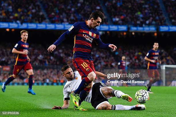 Lionel Messi of FC Barcelona competes for the ball with Guilherme Siqueira of Valencia CF during the La Liga match between FC Barcelona and Valencia...