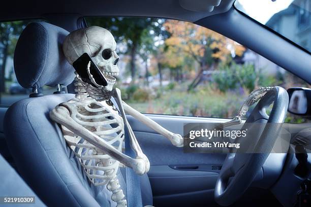 dangerous driver using mobile phone while driving in car - skeleton stock pictures, royalty-free photos & images