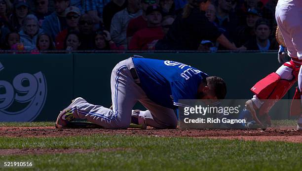 Chris Colabello of the Toronto Blue Jays is on the ground after being hit in the head by a pitch thrown by Steven Wright of the Boston Red Sox during...