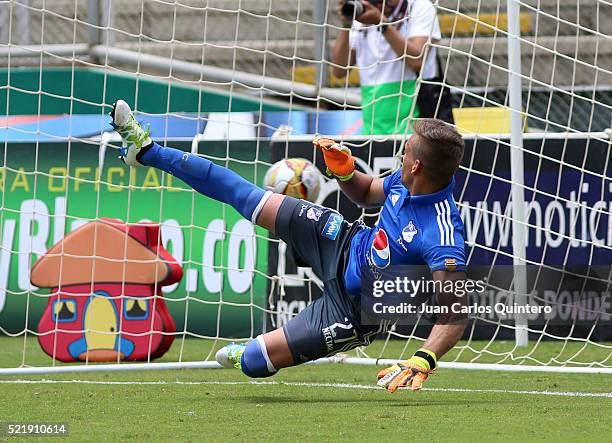 Nicolas Vikonis of Millonarios fails to stop a penalty by Fabian Sambueza of Cai during a match between Deportivo Cali and Millonarios as part of...