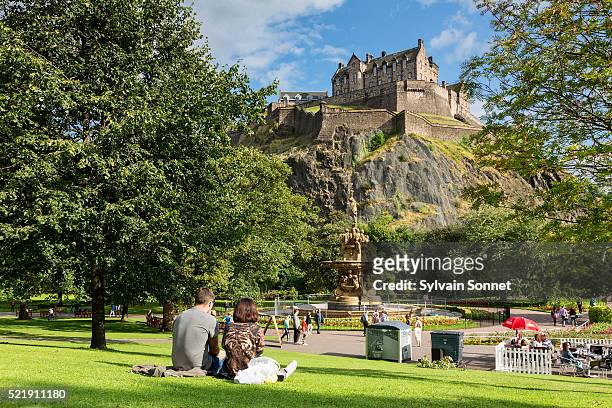 edinburgh castle and the ross fountain as seen from princes street gardens - edinburgh castle people stock pictures, royalty-free photos & images