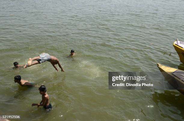 children are bathing in ganga river on varanasi ghat at uttar pradesh, india - bathing ghat fotografías e imágenes de stock