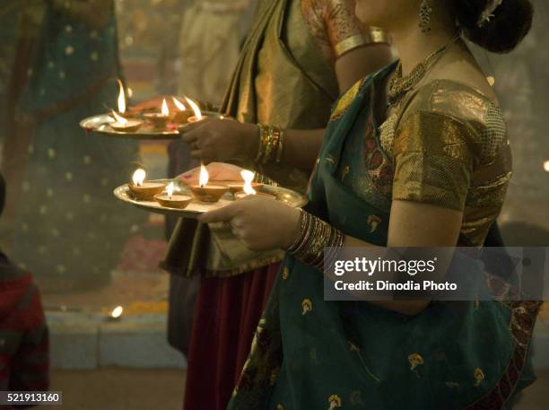 girl holding aarti thali during ganga aarti, varanasi, benaras, uttar pradesh, india - arctis stock pictures, royalty-free photos & images