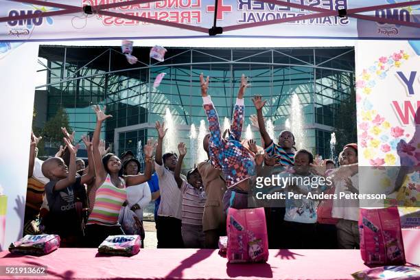 Shoppers attend a promotion for a detergent brand on May 1, 2013 at Maponya shopping Mall, Soweto, South Africa. Maponya is one of several new...