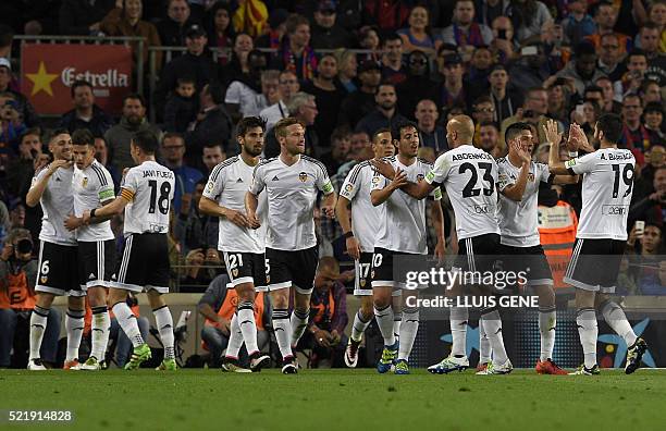 Valencia's Brazilian midfielder Guilherme Siqueira celebrates with teammates after scoring a goal during the Spanish league football match FC...