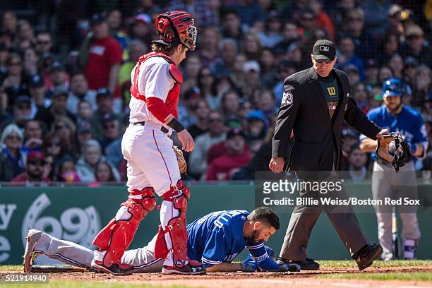 Chris Colabello of the Toronto Blue Jays falls to the ground after being hit in the head with a pitch during the fourth inning of a game against the...