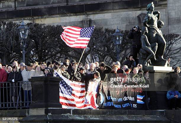 People waving American Flags watch the Neo-Nazis march during the 60th anniversary of the fire-bombing of Dresden by Allied bombers during World War...