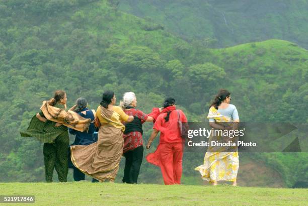 old women in mist at malshej ghat, maharashtra, india - malshej ghat stockfoto's en -beelden