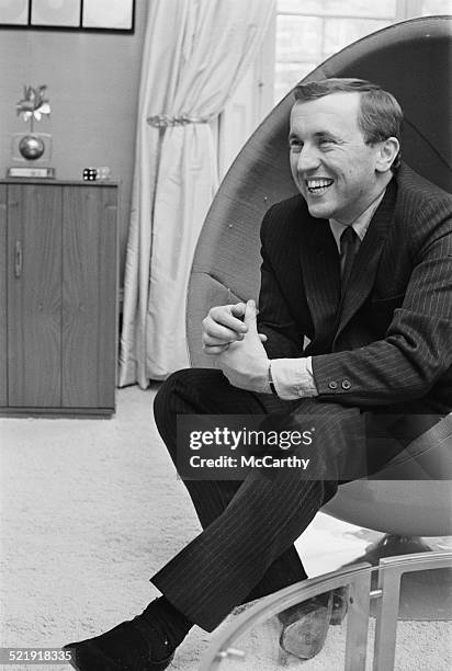 English journalist and television host David Frost relaxing at home, 1969.
