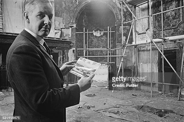 British historian and Director General of the Imperial War Museum, Noble Frankland, during renovations of the reading room which has been damaged...