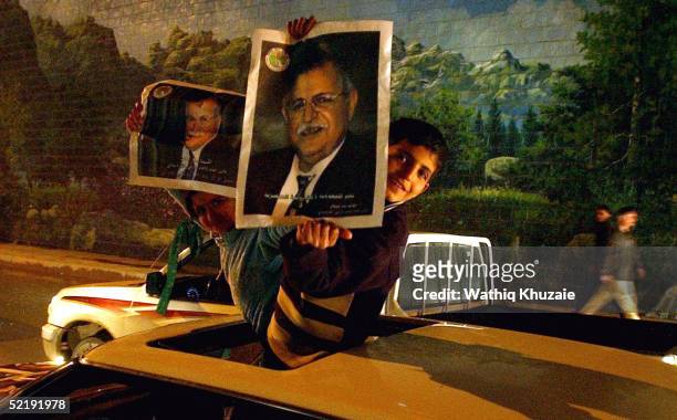 Iraqi Kurdish children hold up pictures of the Kurdish leader Jalal Talabani as they celebrate the results of general elections February 13, 2005 in...