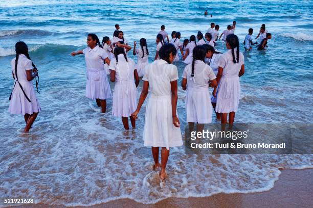 sri lanka, trincomalee, shcool girls play on the sea - trincomalee stock pictures, royalty-free photos & images
