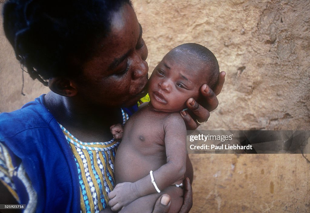 A proud mother kisses her new born baby